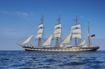 Naklejka na ściany i meble Tall Ship under sail with the shore in the background