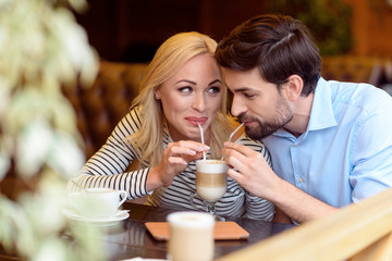 Cute loving couple enjoying hot drink together