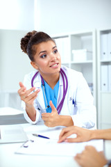 Doctor and patient sitting on the desk at office