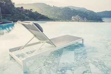 Luxury swimming pool and blue water at the resort with beautiful