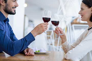 Cheerful man and woman drinking wine