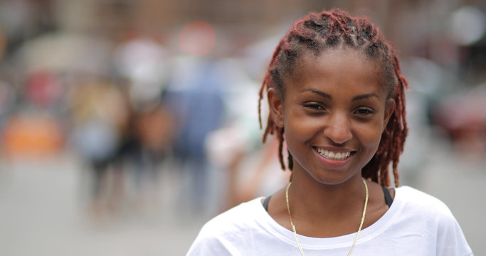 Young latina woman in city face portrait smile happy