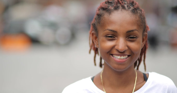 Young latina woman in city face portrait smile happy