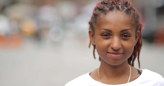 Young latina woman in city face portrait smile happy