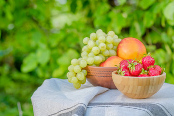 Strawberries in a wooden bowl. Fresh juicy fruit on a natural ba