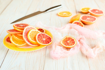Citrus fruits and knife on wooden table. Cooking concept