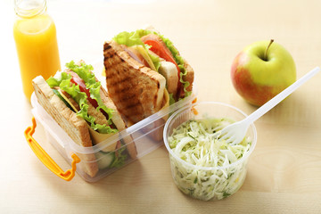 Tasty and fresh sandwiches on a brown table