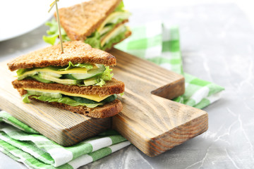 Tasty and fresh sandwiches on a grey table