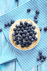 Homemade blueberry tart on blue wooden table