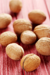 Walnuts on a red wooden table