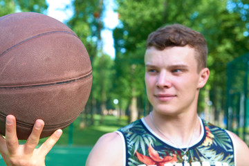Man with basketball ball standing on playground