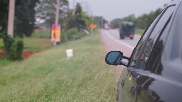 A black car parked on the roadside