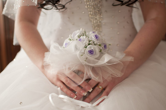 A bride is holding wedding bouquet 