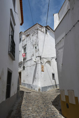 Cobbled road forking, historic center of Evora, Portugal