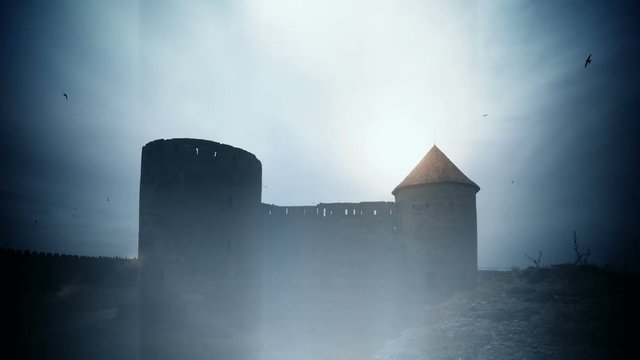 Silhouette of a ruin of dark castle with flying black birds timelapse 