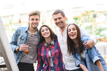 Group of young friends meeting in cafe