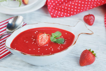 A bowl of strawberry soup gazpacho with mint
