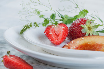 Strawberry and peach with mint on a white heard shape plate