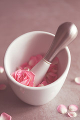 Petals in mortar on grey background