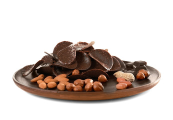 Chocolate chips and different nuts in brown plate on white background