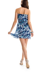 Woman in blue strapless dress. Back view of young lady. Stylish design of summer garment. Slim model wears heel shoes.