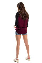 Woman in dark-colored top. White shoes and jeans shorts. Trendy design and quality materials. Nice-looking model.