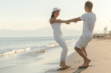 Young couple playing about beach