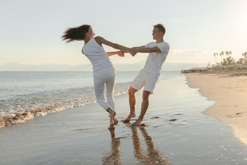 Young couple playing about beach