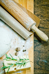 Ingredients for homemade pizza with a pile of bread dough