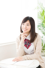 asian schoolgirl studying in the cafe