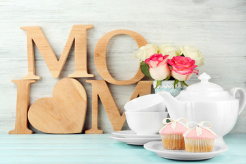 Mother's day decorations on light wooden background