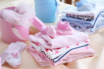 New baby clothes on bed