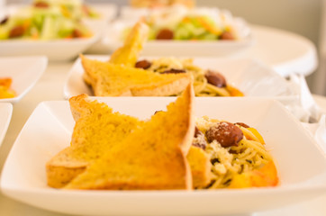 Spaghetti with bread vegetable sala in the background photo image