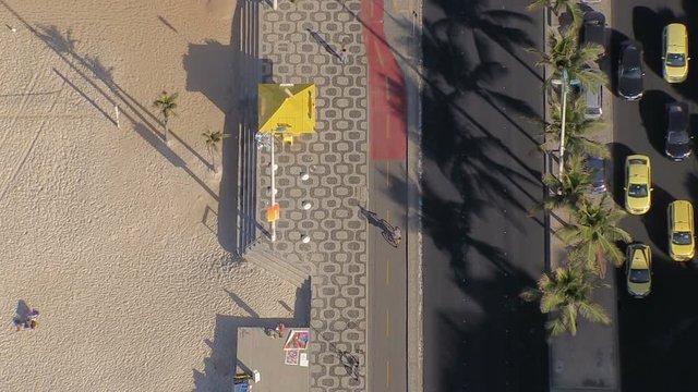 Flying directly above Ipanema Beach mosaic sidewalk, Rio De Janeiro, Brazil