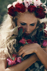 Retro vintage style portrait of beautiful blonde woman with rose