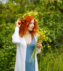 Girl holding a bouquet of wildflowers.
