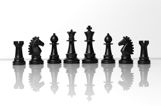 Black chess pieces in a row, teamwork
