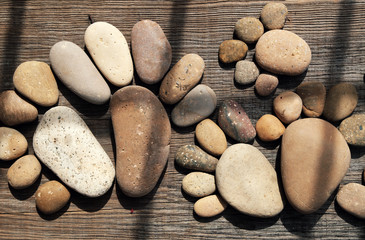 Fototapeta na wymiar Abstract cute pebbles, footprint from boulder