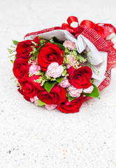 Fototapeta na wymiar Red roses put on white stone table background