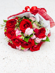 Red roses put on white stone table background