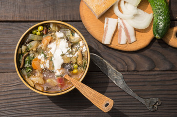 Borscht with sour cream in a deep plate