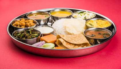 indian food platter, indian thali, indian veg thali,paratha, rice, aalu bhaji,puri or poori, complete meal, south indian thali © StockImageFactory