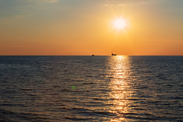 Naklejka na ściany i meble Beautiful reflection of rays setting sun in the Black Sea.