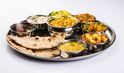 indian food platter, indian thali, indian veg thali,paratha, rice, aalu bhaji,puri or poori, complete meal, south indian thali © StockImageFactory