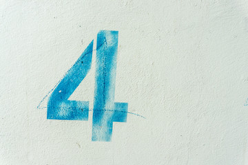 the number 4 on the dirty white wall - obrazy, fototapety, plakaty