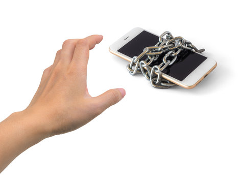 Human hand trying to catch chained smart phone isolate on white background with clipping path and copy space. Concept of social network issues, security, phubbing, smart phone addiction