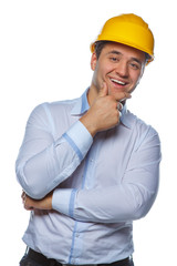 Portrait of positive worker male in yellow safe helmet.