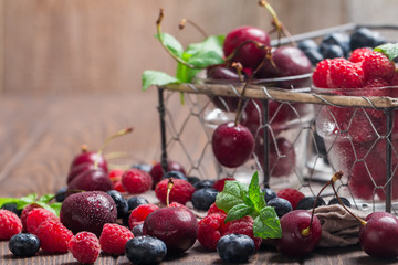 small glasses of fruit containing cherry, blueberry and rasberry