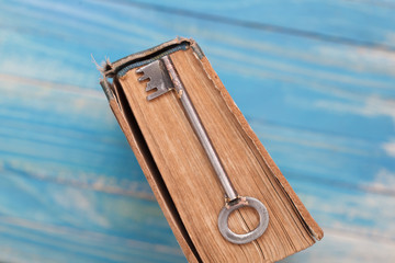 Top View of Vintage book with old grunge paper textured pages and rusty key