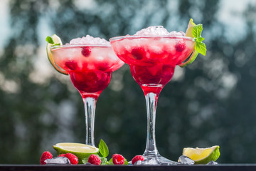 margarita cocktail with lime and raspberries